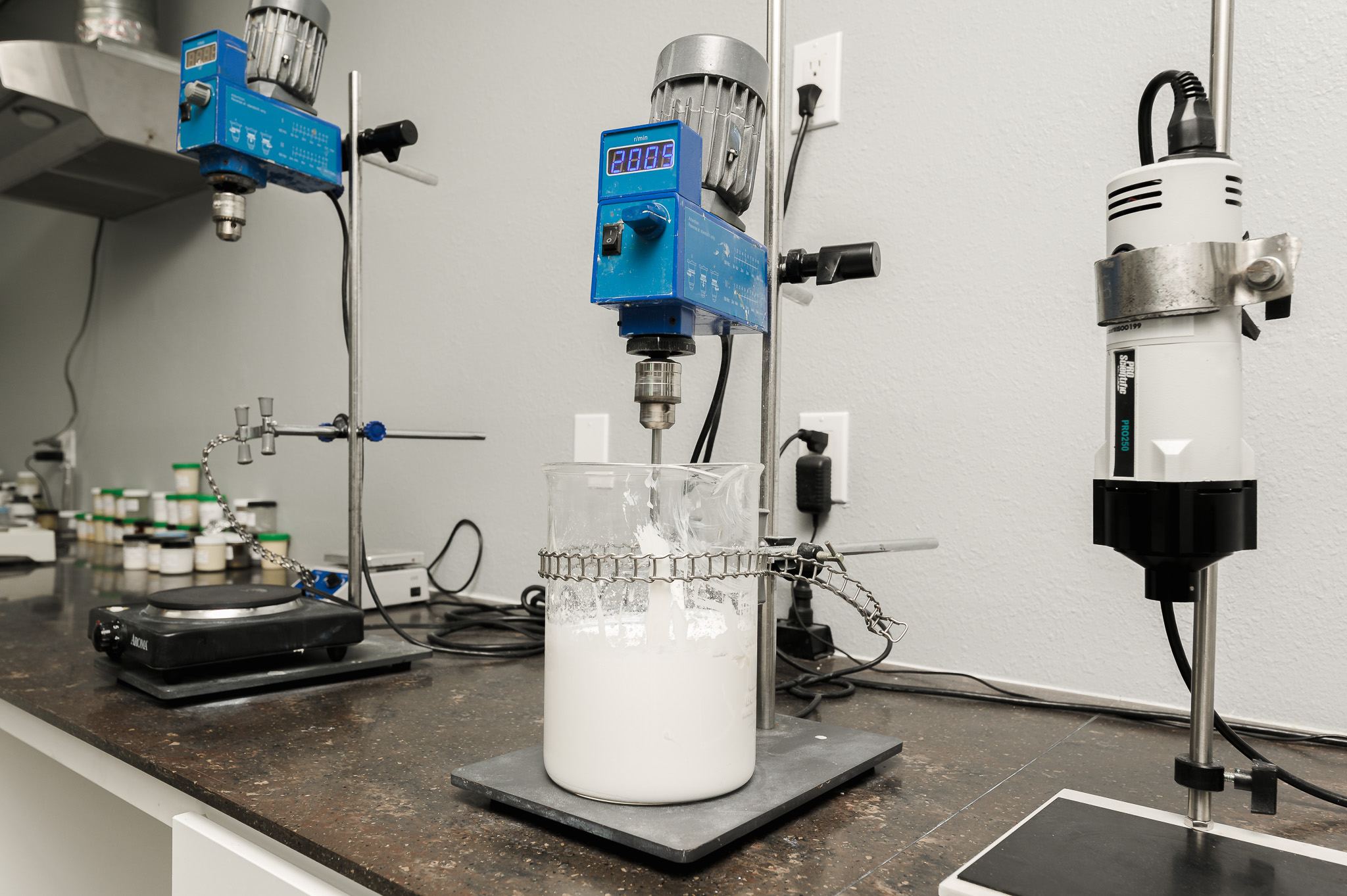 Overhead mixers blending a cream formulation on the lab bench