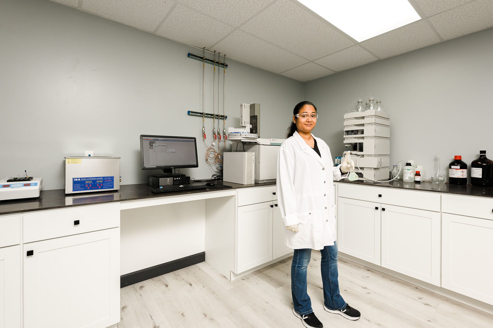 Chemist in the analytical lab with the HPLC system used for active-ingredient testing