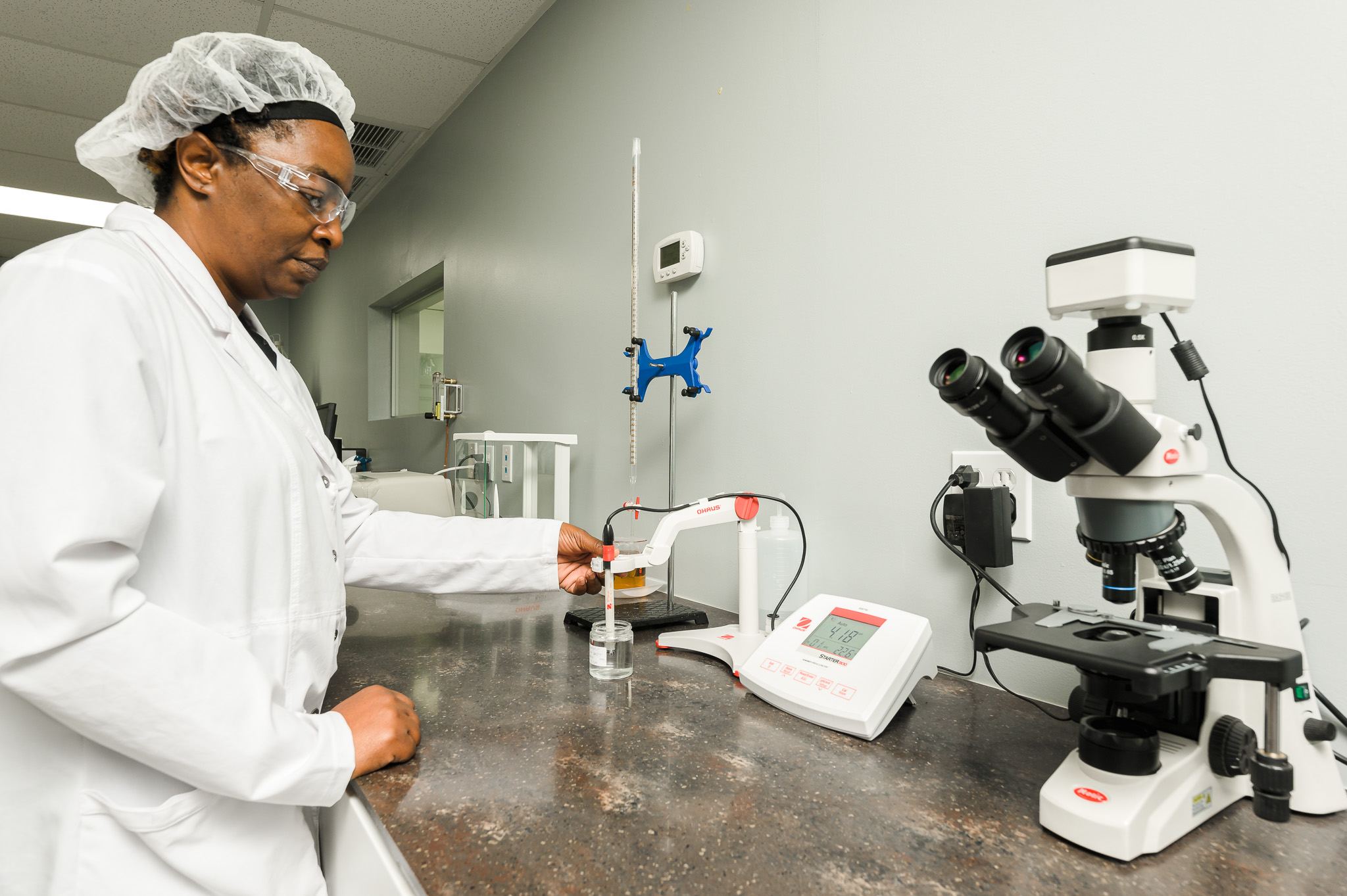 Lab technician testing a liquid sample with a pH meter