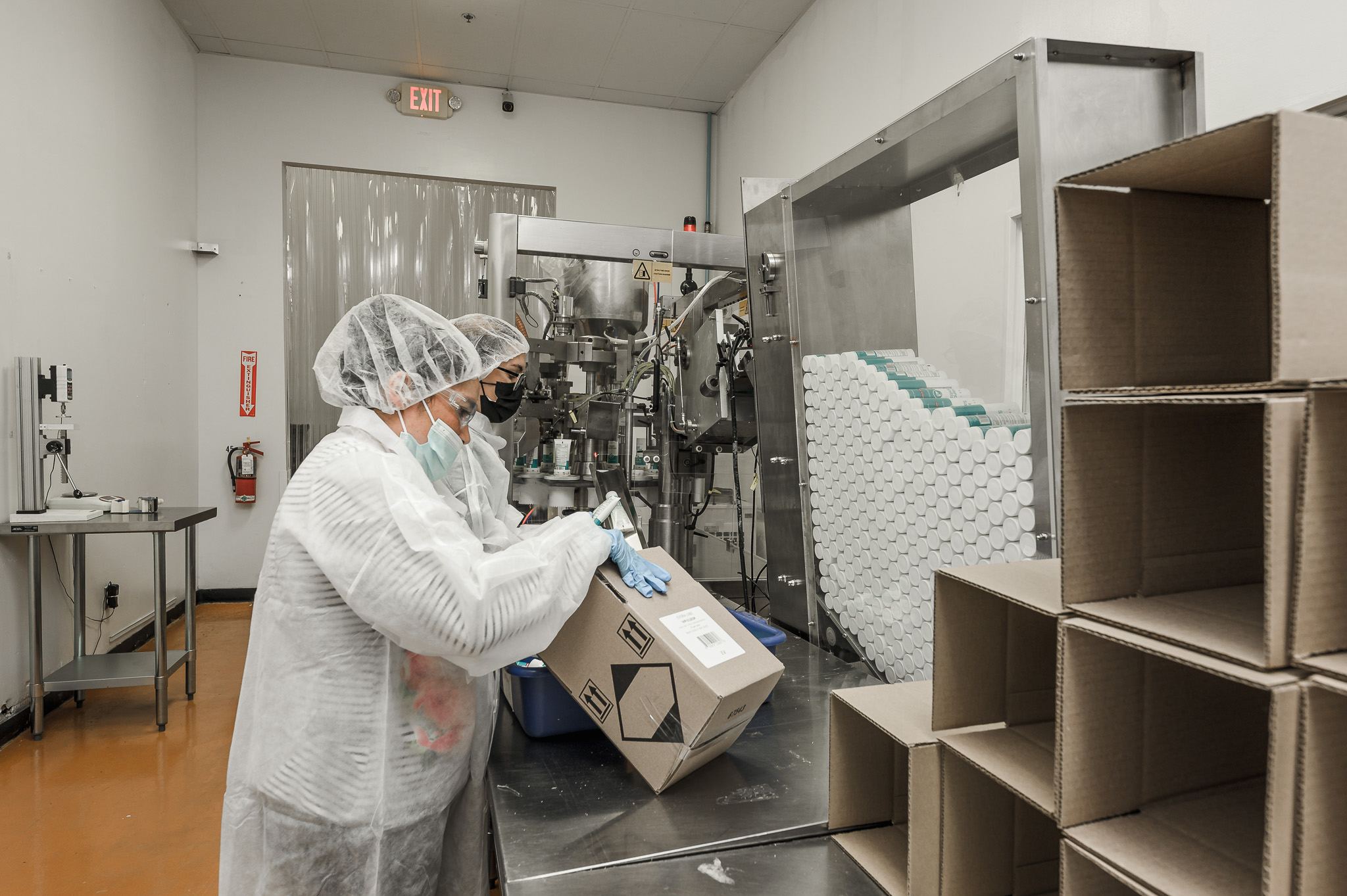 Team packing finished units on the packaging line