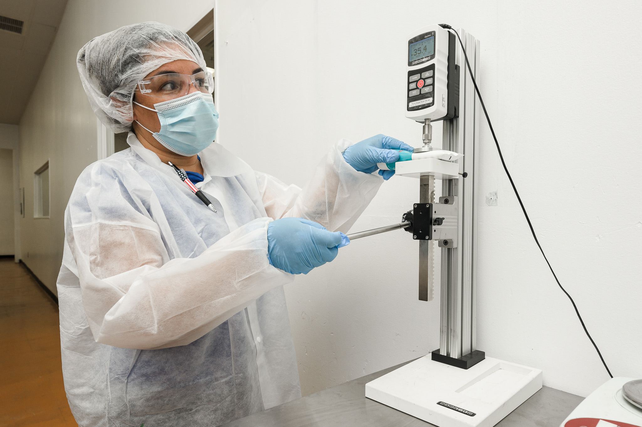 QC technician performing force testing on a sample