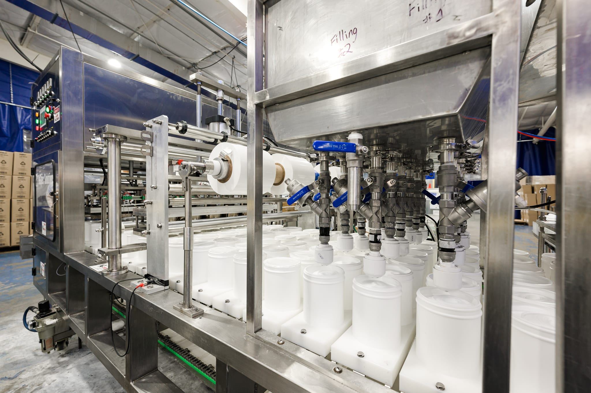 Automated filling line for wipes canisters and pails